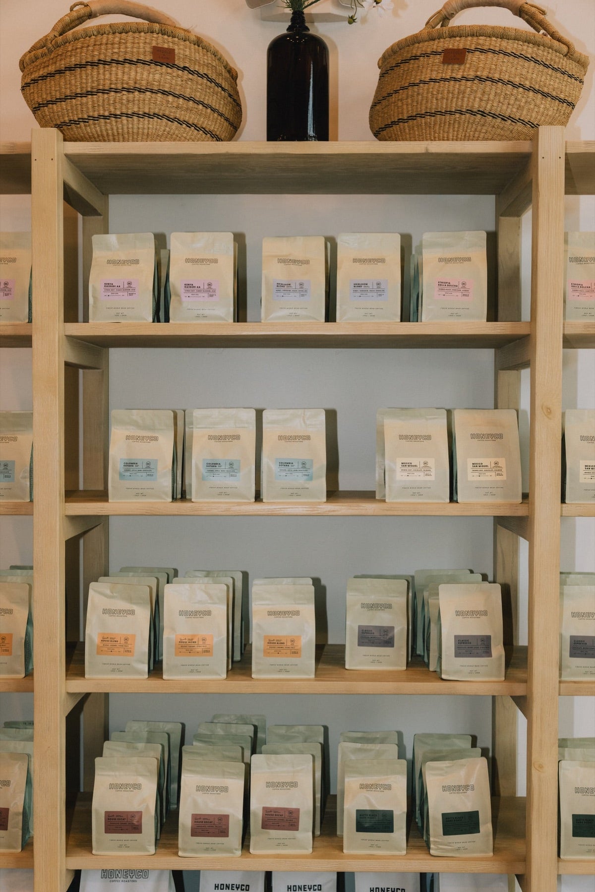 Bags of HoneyCo coffee on the shelf