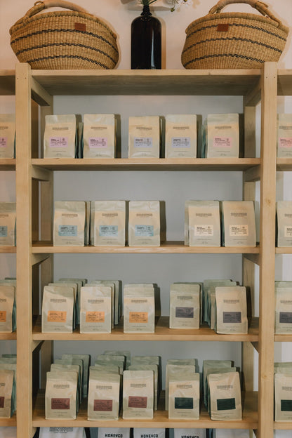 Bags of HoneyCo coffee on the shelf