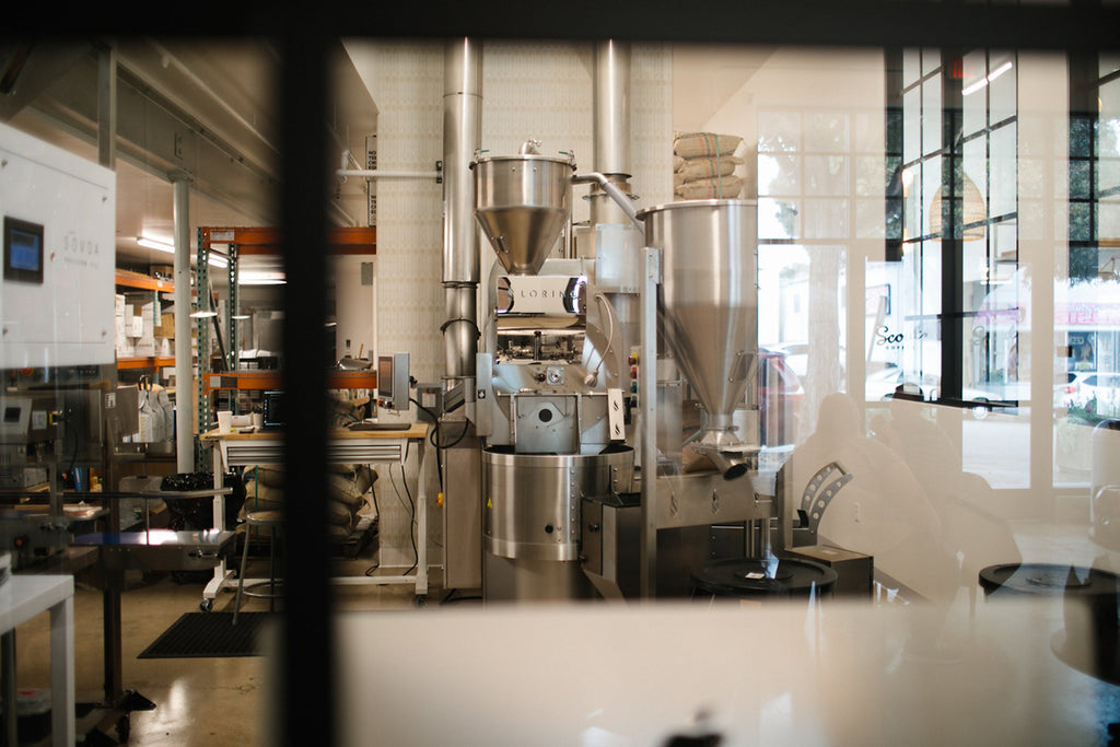 The Loring roaster seen through the window of the HoneyCo roastery in Morro Bay